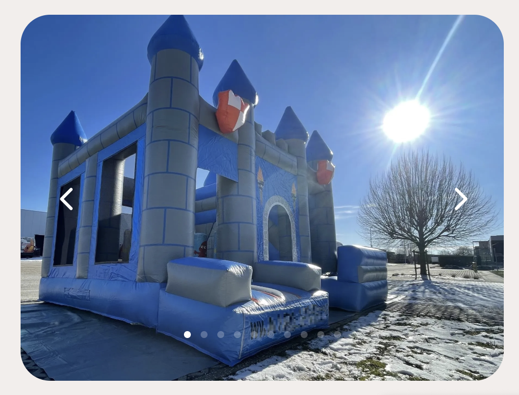 Image d'un chateau gonflable qui ressemble à un chateau mediéval, pierre grise et toit bleu